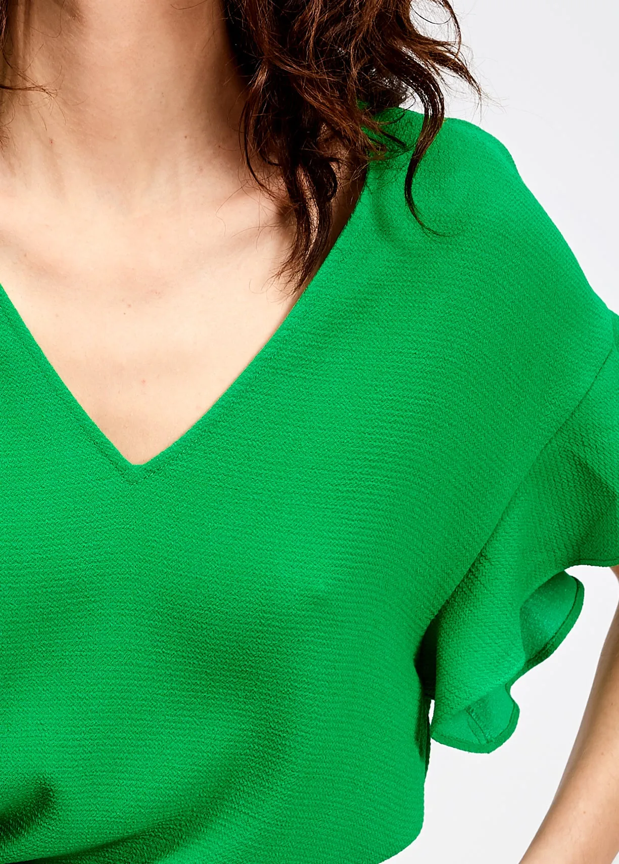 Green v-neck top with ruffled sleeves